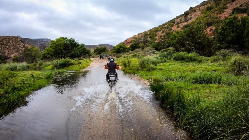 Adventure Bike Riding through a stream in Baviaanskloof, South Africa