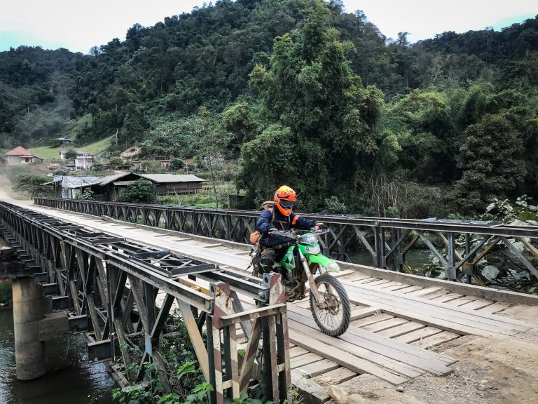 Riding across a bridge in Laos.