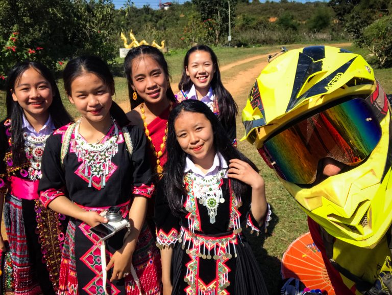 Toby and some locals having a photo taken in Laos.
