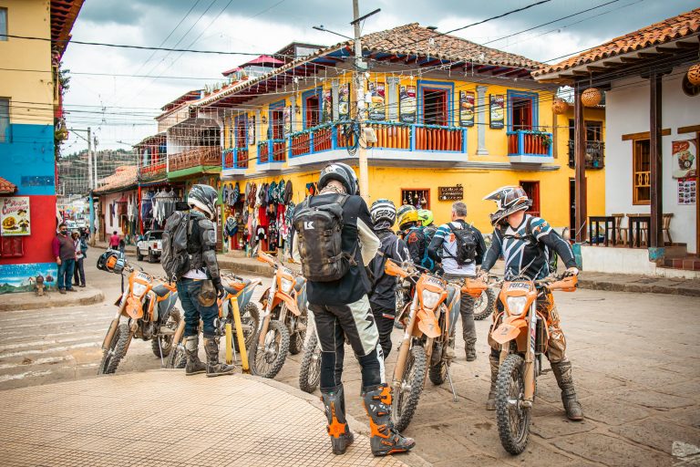 Dirt bike riders gathered in a colourful Colombian town