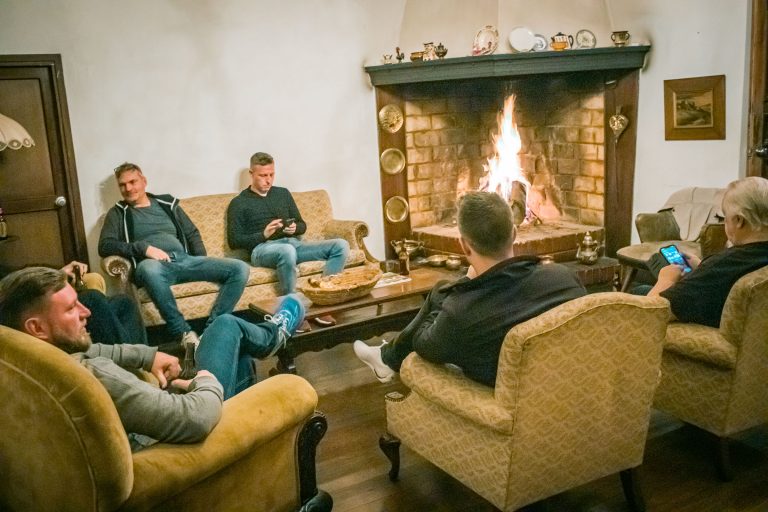 Riders relaxing by the fireplace at a colonial hacienda in Ubaté, Colombia