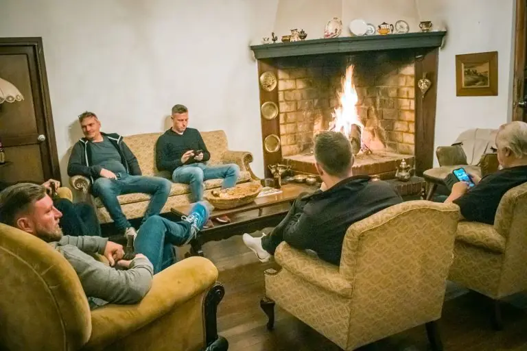 Riders relaxing by the fireplace at a colonial hacienda in Ubaté, Colombia