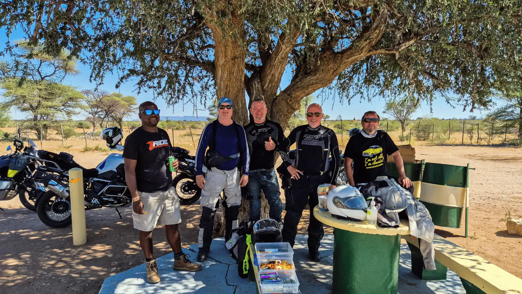 cape-town-to-victoria-falls-motorcycle-tour-group-under-tree-03