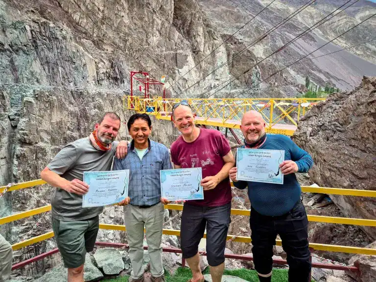 4 men holding a bungee jumping certificate in Ladakh
