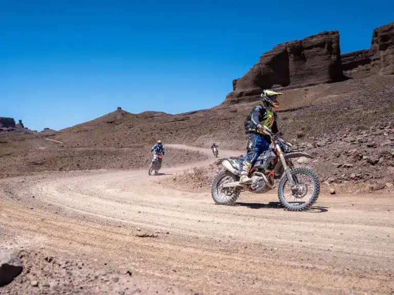 Motorcyclists zipping through dusty tracks in Morocco.